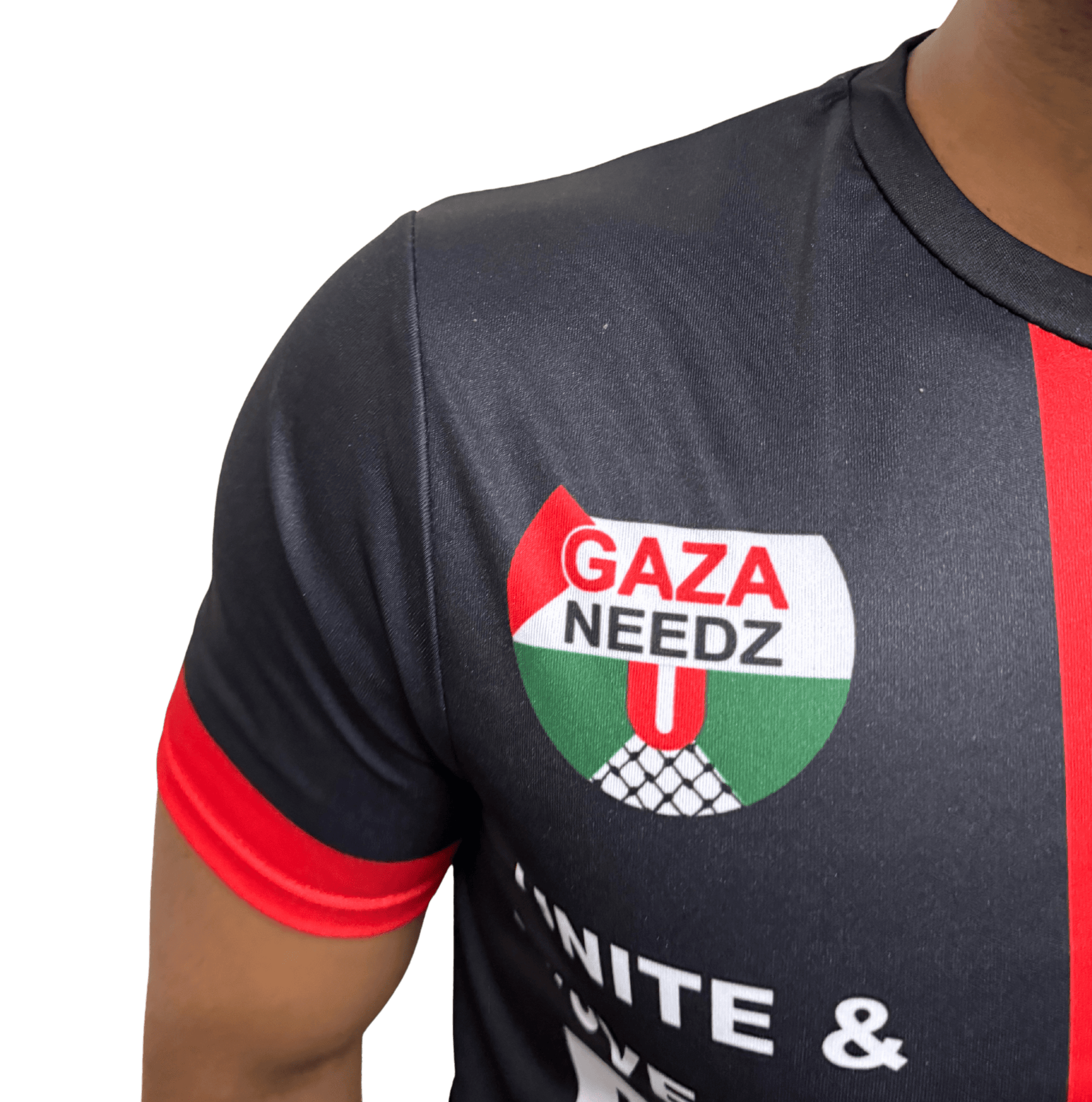 Close-up of Gaza Needs You emblem (Palestine flag with text) on black Palestine football jersey