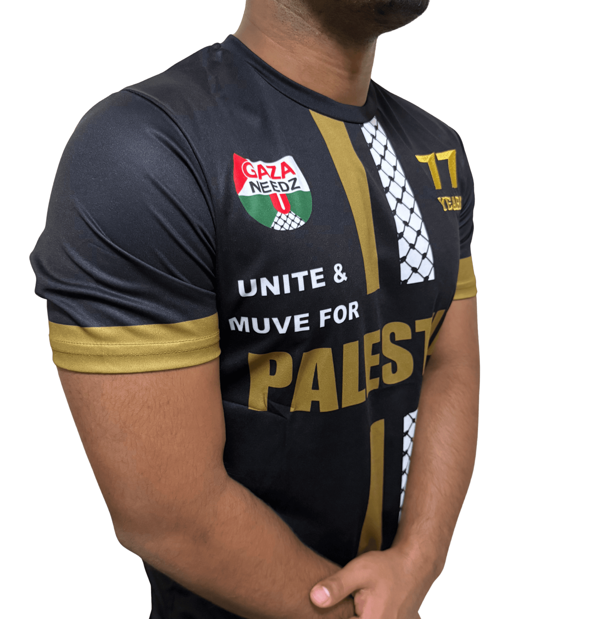 Side view of black and gold Palestine football jersey with gold and white stripes, Gaza Needs You emblem, and 77 Years gold logo